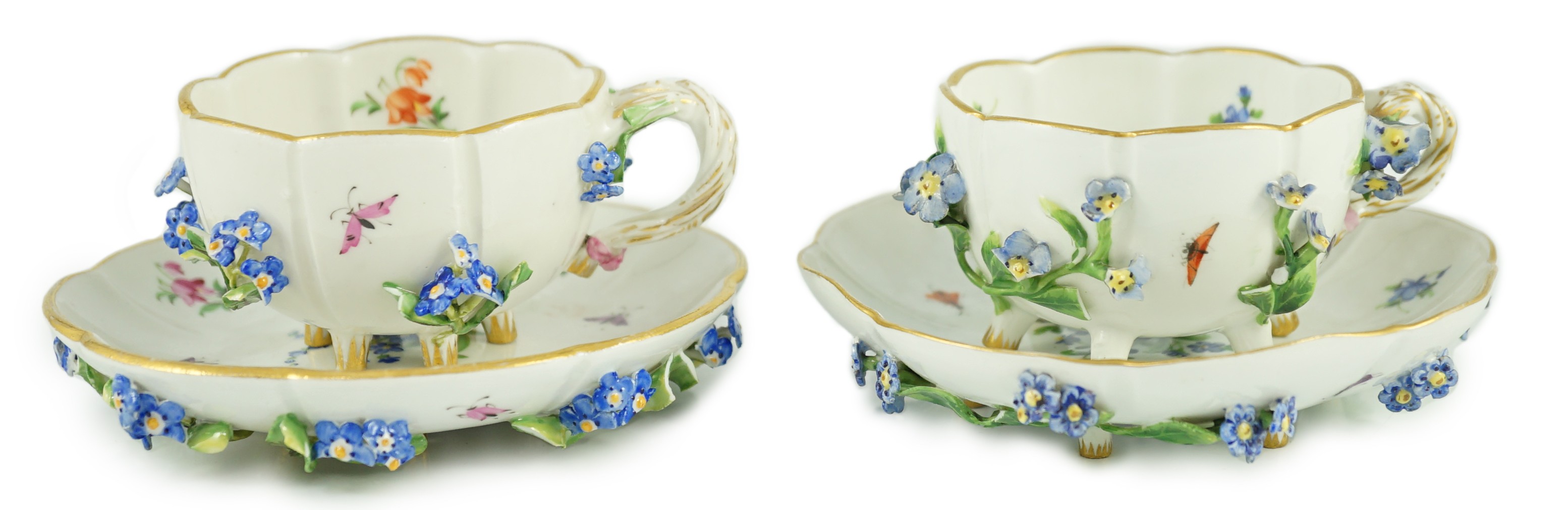Two Meissen flower encrusted cups and saucers, 19th century, saucers 12cm wide, chips to flowers and leaves
